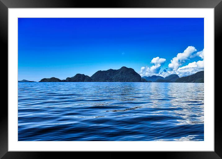 island and blue sky Framed Mounted Print by John Lusikooy