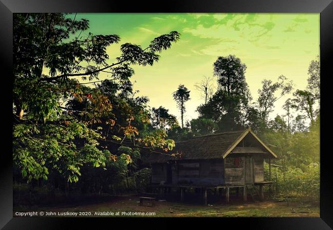 cabin house on the edge of the jungle Framed Print by John Lusikooy