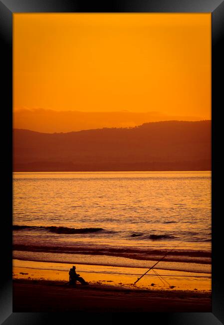 Lone fisherman at sunset on Berrow Beach Somerset Framed Print by Cliff Kinch