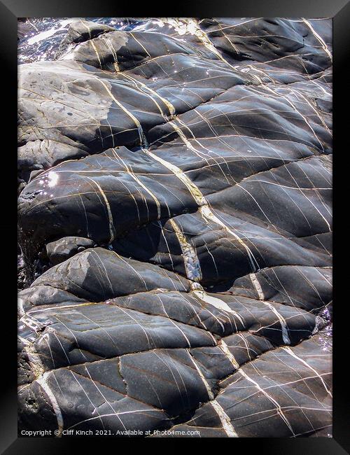 Glistening sea-washed rocks Framed Print by Cliff Kinch