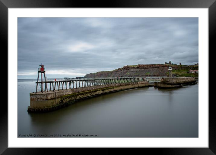 Whitby Pier with the lighthouse & Whitby Abbey in the distance.  Framed Mounted Print by Vicky Outen