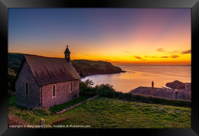 A sunset over the sea with a church in the foreground Framed Print by Gary Holpin