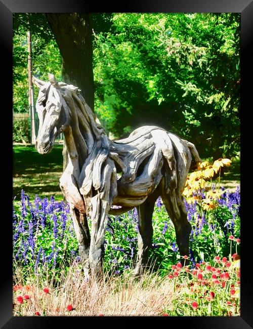 A wooden horse standing in flowers Framed Print by Stephanie Moore