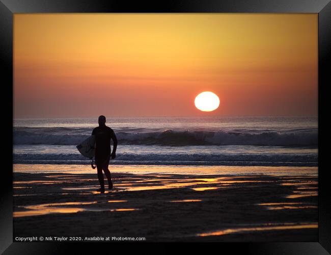 Surfer at Sunset Framed Print by Nik Taylor