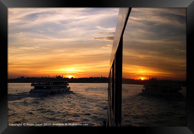 A sunset in Istanbul with the reflections on a boats windows 2 Framed Print by Engin Sezer