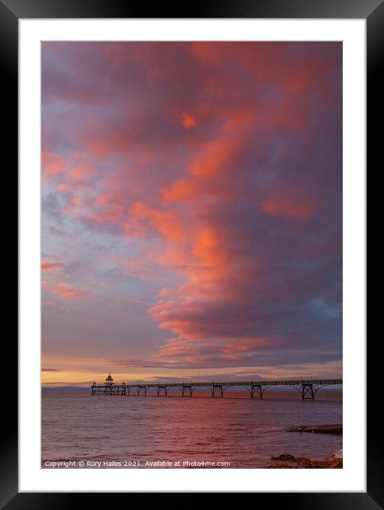 Clevedon Pier with the cloud cover catching the colourful sunlight Framed Mounted Print by Rory Hailes