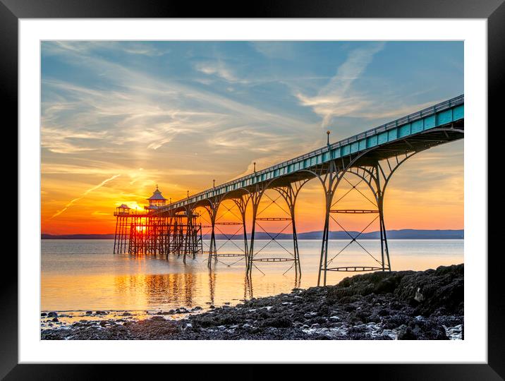 Clevedon Pier on a bright evening with colourful reflections Framed Mounted Print by Rory Hailes