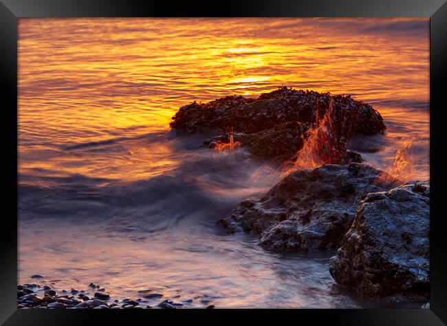 Sunset rocks with a splash Framed Print by Rory Hailes