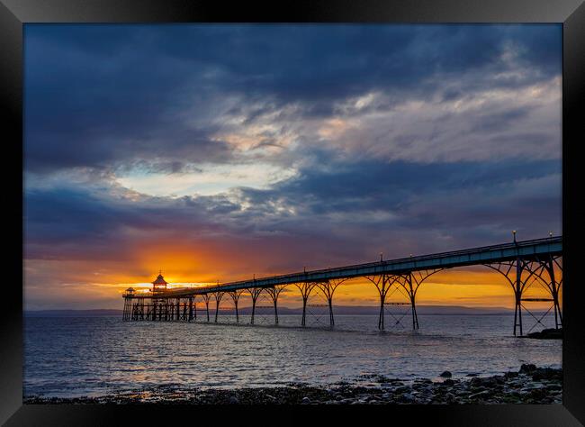 Clevedon Pier at sunset on a cloudy evening Framed Print by Rory Hailes