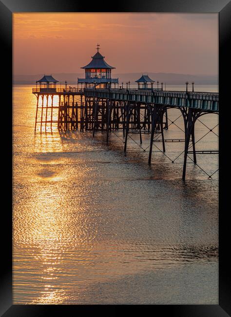 Clevedon Pier with a golden reflection on the sea Framed Print by Rory Hailes