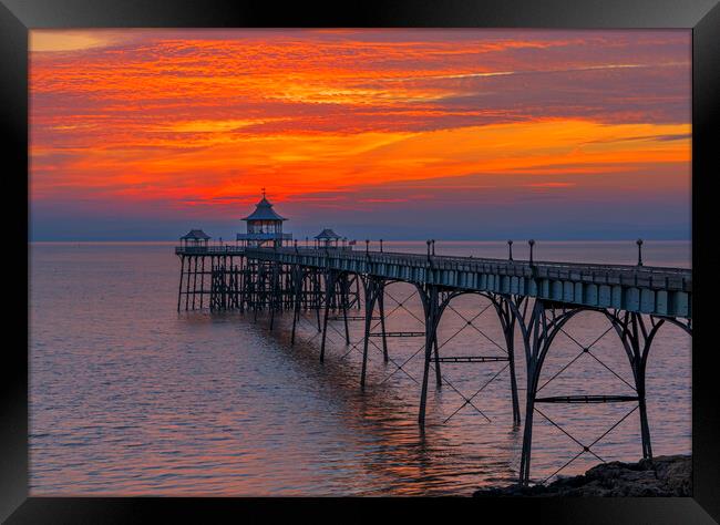Clevedon Pier with brigh reddish orangey horizon Framed Print by Rory Hailes