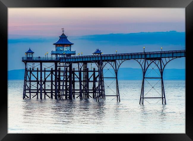 Clevedon Pier on a calm evening with a slight bluish hue Framed Print by Rory Hailes