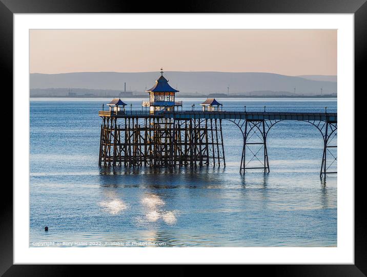 Clevedon Pier with sunlight reflecting onto the sea Framed Mounted Print by Rory Hailes