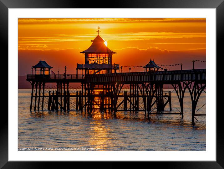 Clevedon at sunset with a streak of sunlight going through the pier head Framed Mounted Print by Rory Hailes