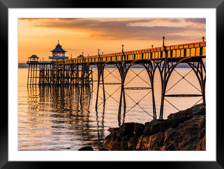 Clevedon Pier at Sunset sunlight reflecting onto the sea Framed Mounted Print by Rory Hailes
