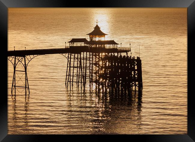 Clevedon Pier at sunset with a calm and tranquil sea Framed Print by Rory Hailes