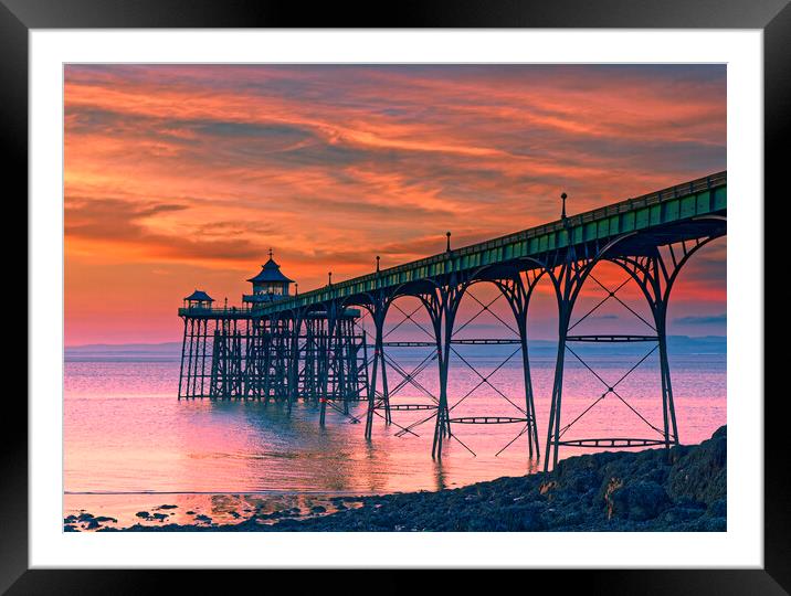 Clevedon Pier at sunset on a calm evening with cloud and blue sky above Framed Mounted Print by Rory Hailes
