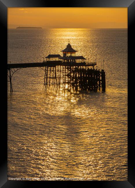 Clevedon Pier at sunset with a calm sea Framed Print by Rory Hailes