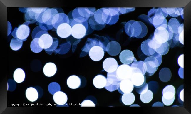 Abstract background of white and blue light halos or circles in a tree Framed Print by SnapT Photography