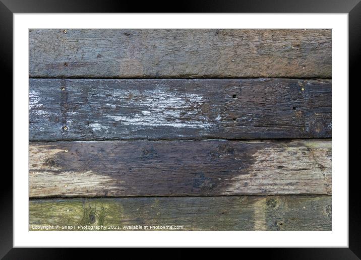 Abstract background of damp stacked wooden railway sleepers covered with frost Framed Mounted Print by SnapT Photography