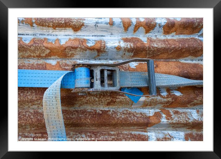 A blue rachet strap wrapped around a rusty corrugated iron metal sheet Framed Mounted Print by SnapT Photography