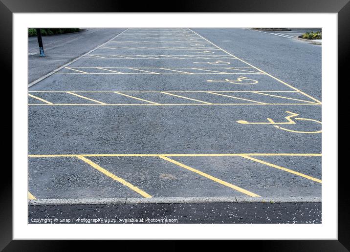 Numerous empty yellow marked disable vehicle parking spaces in a car park Framed Mounted Print by SnapT Photography