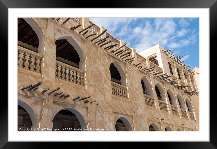 Middle eastern architecture with bamboo wooden poles sticking out of a building Framed Mounted Print by SnapT Photography