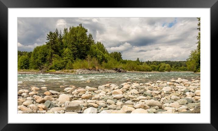 A boulder strewn, fast flowing river, beside a forest, on a cloudy day. Framed Mounted Print by SnapT Photography