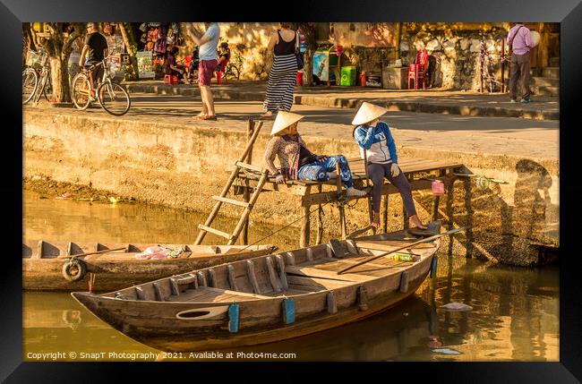 Two vietnamese ladies with conical hats relaxing by the river Framed Print by SnapT Photography