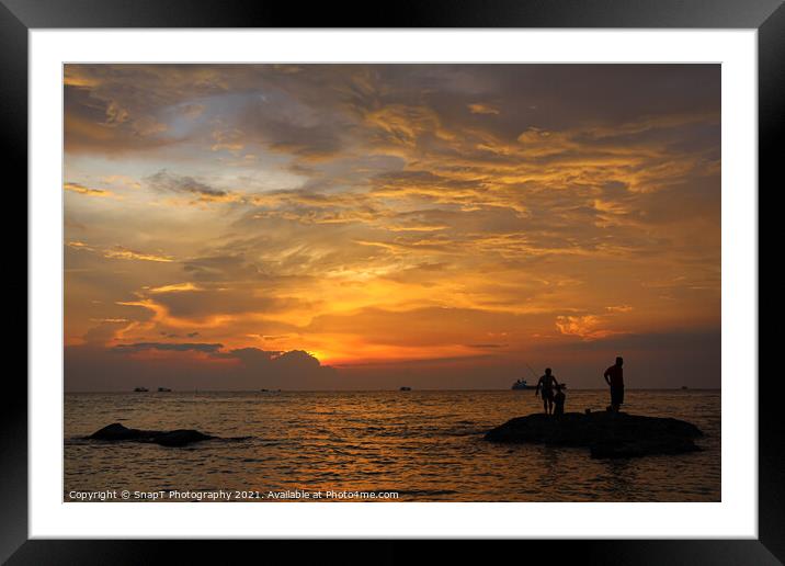 A silhouette of fishermen standing on rocks at sun Framed Mounted Print by SnapT Photography