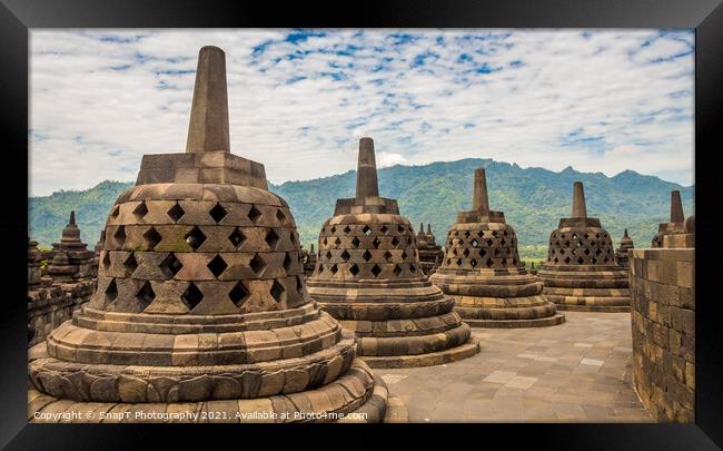 Stupas that look like bells on top of the Borobudur Buddhist temple, Indonesia Framed Print by SnapT Photography