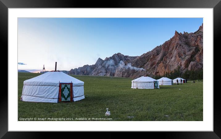 A row of Mongolian gers at a camp at sunset on a summers night, with chimney smoke Framed Mounted Print by SnapT Photography