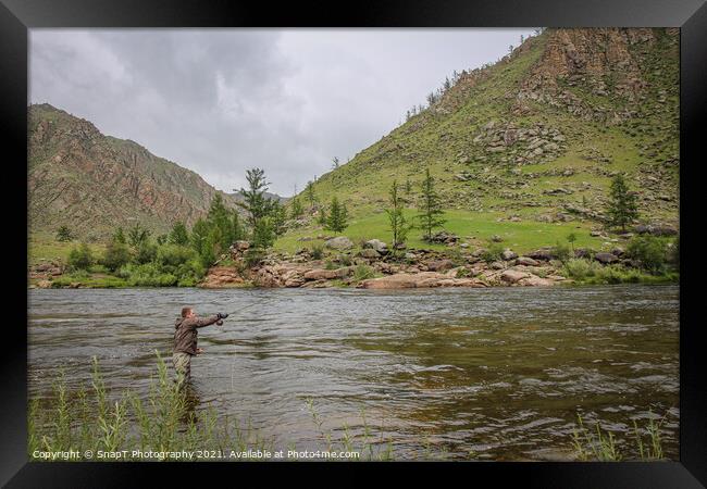 Fly fisherman casting a fly on a river in Mongolia during the summer, Moron, Mongolia Framed Print by SnapT Photography