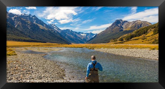 An fly fisherman looking for trout in the mountains of the Ahuriri River Framed Print by SnapT Photography