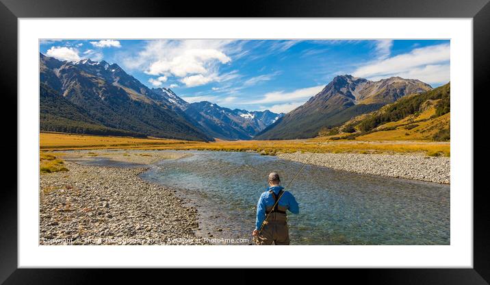 An fly fisherman looking for trout in the mountains of the Ahuriri River Framed Mounted Print by SnapT Photography