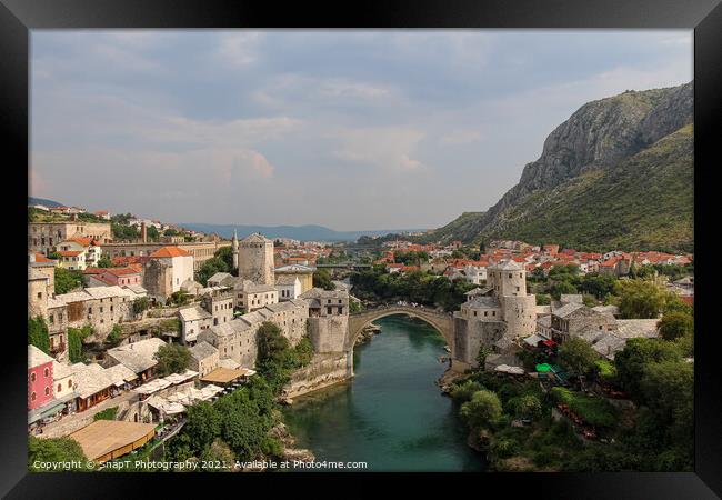 A landscape view of the old town of Mostar, with the old bridge over the river Framed Print by SnapT Photography
