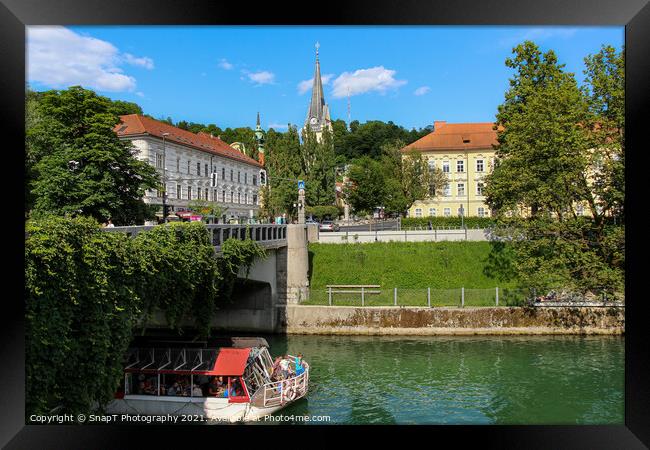 A tourist boat passing under the St. James Bridge on the Ljublijanica River Framed Print by SnapT Photography