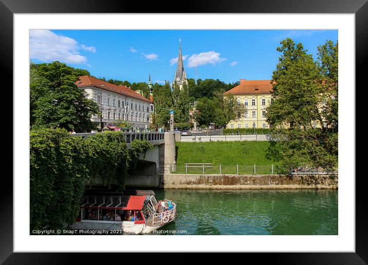 A tourist boat passing under the St. James Bridge on the Ljublijanica River Framed Mounted Print by SnapT Photography