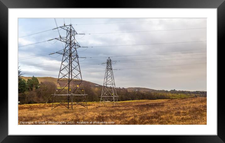Electricity pylons in a field on a cloudy day in winter at Kendoon Power Station Framed Mounted Print by SnapT Photography