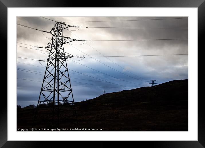 Electricity pylons in a field on a cloudy day in w Framed Mounted Print by SnapT Photography