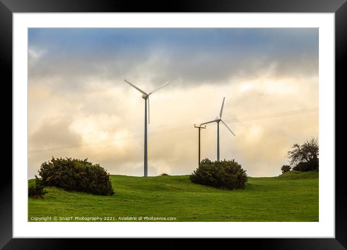 Wind turbines in a green field on the horizon on a cloudy day at sunset Framed Mounted Print by SnapT Photography