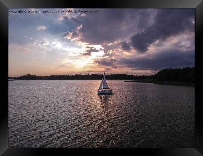 Sailing boat with a beautiful sunset Framed Print by Wojciech Jagoda