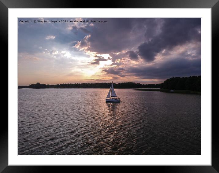 Sailing boat with a beautiful sunset Framed Mounted Print by Wojciech Jagoda