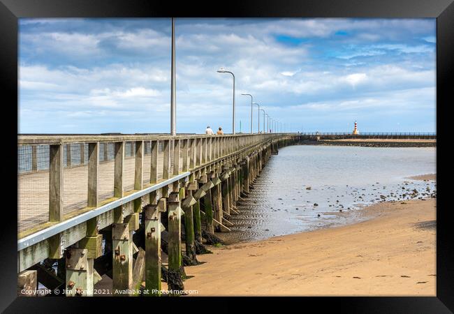 Amble pier and lighthouse Framed Print by Jim Monk