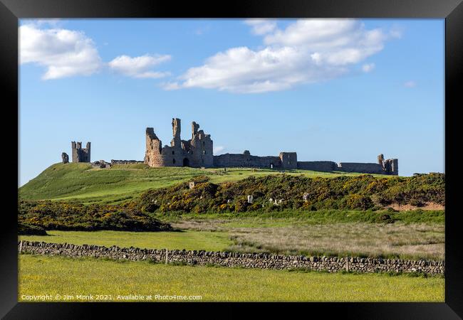 Dunstanburgh Castle in Northumberland Framed Print by Jim Monk