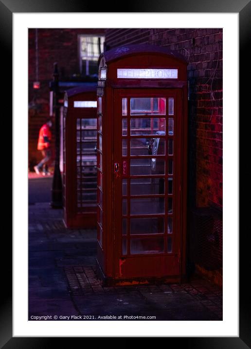 Red English Telephone boxes in a night time street Framed Mounted Print by That Foto