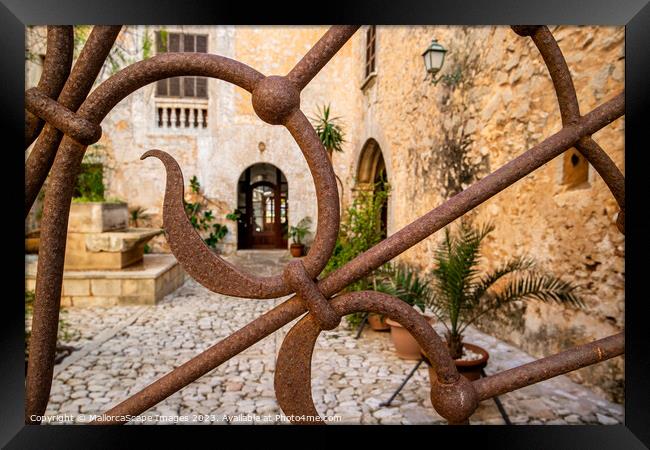 Ornamental iron gate with view into a mediterranea Framed Print by MallorcaScape Images