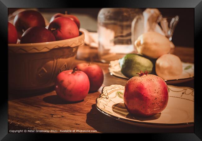 Festive Pomegranate & English Apples On A Rustic Kitchen Table Framed Print by Peter Greenway