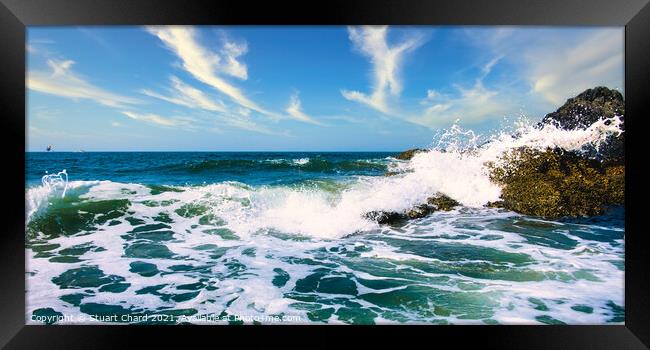 Waves crashing over the rocks with surf and spray Framed Print by Stuart Chard