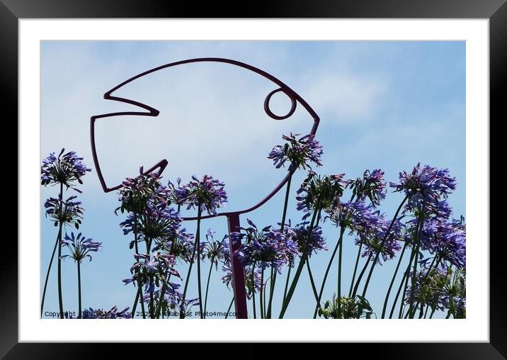 Fish sculpture with agapanthus flowers Framed Mounted Print by Peter Wiseman